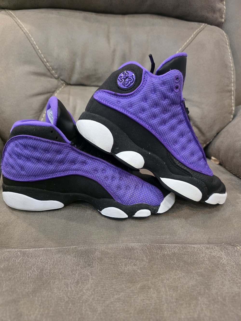 Nike Air Jordan 13 Retro basketball shoes in a "Purple Venom" colorway.